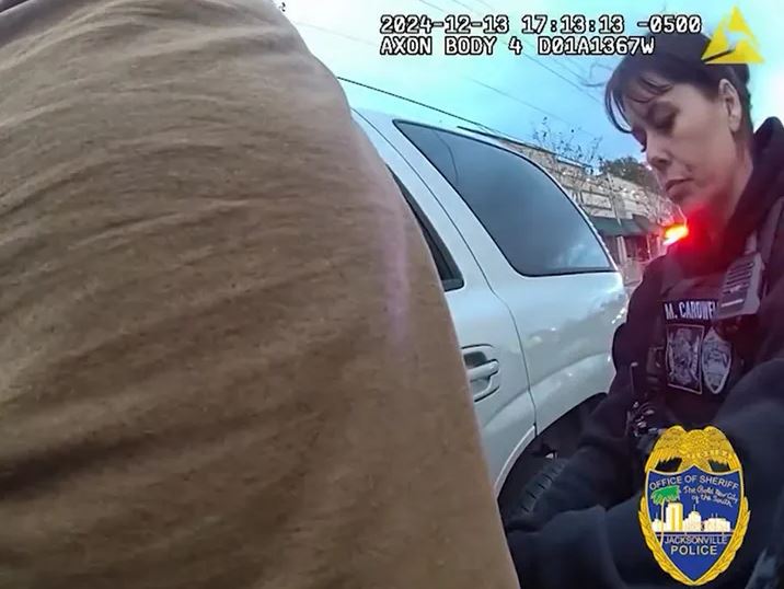 Bodycam footage of a police officer frisking a suspect.