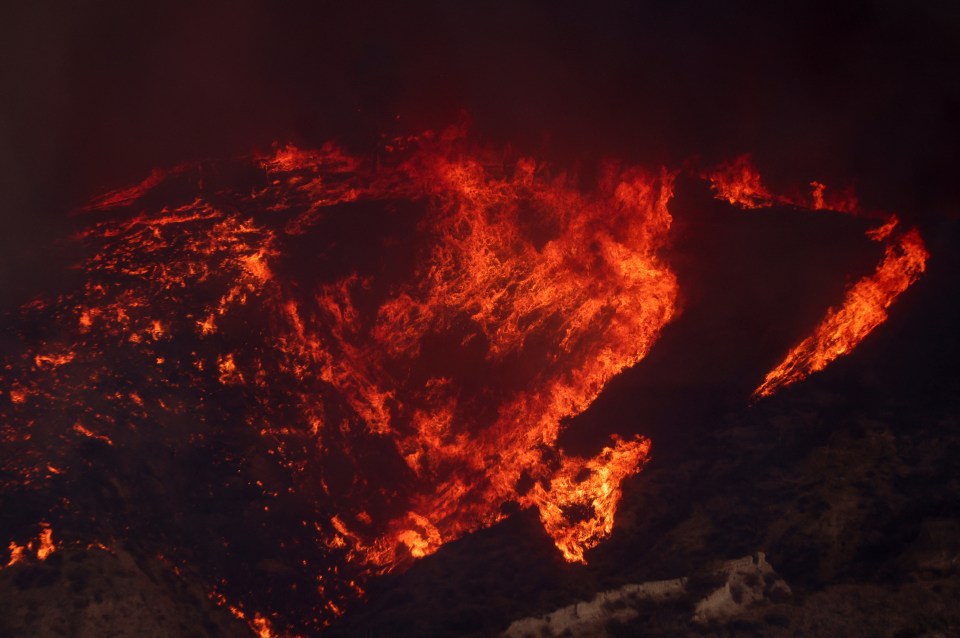 Intense flames and smoke from a wildfire.