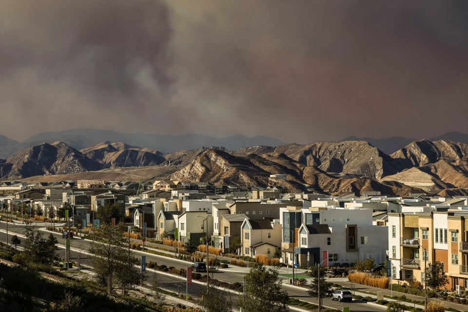 Smoke from the Hughes wildfire over suburban homes in Santa Clarita, California.