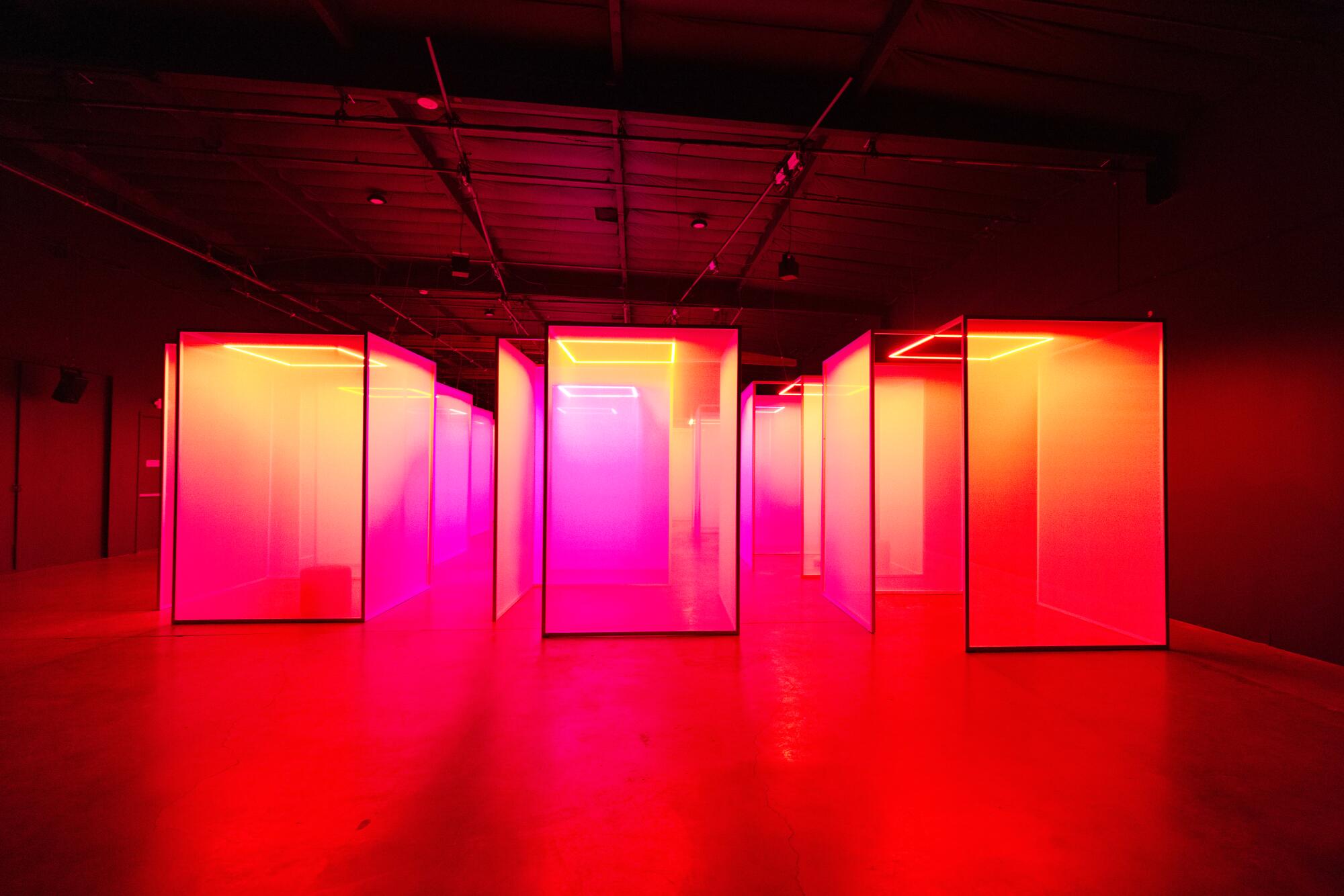 A corridor of scrims in a red hue. 