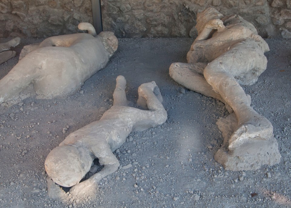 Three plaster casts of Pompeii victims buried by volcanic ash.