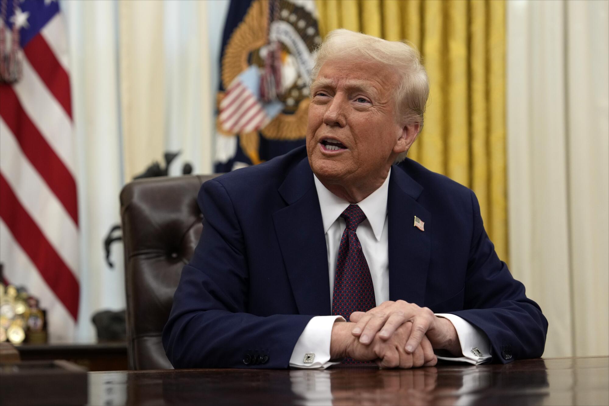 A man sits at a desk.