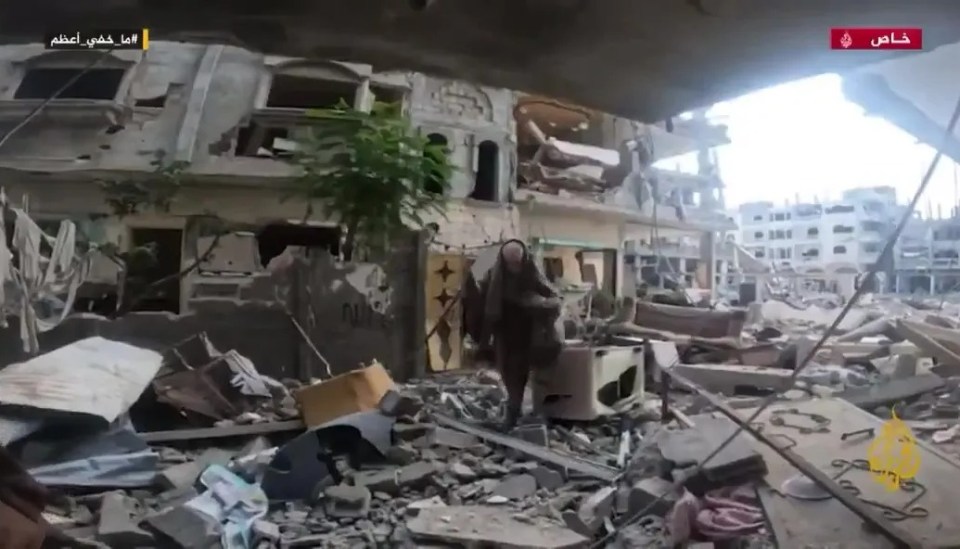 Footage of a woman walking through rubble in Gaza.