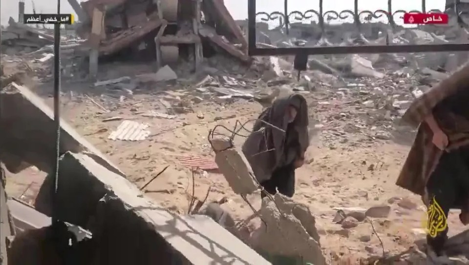 Footage of a person amidst rubble.