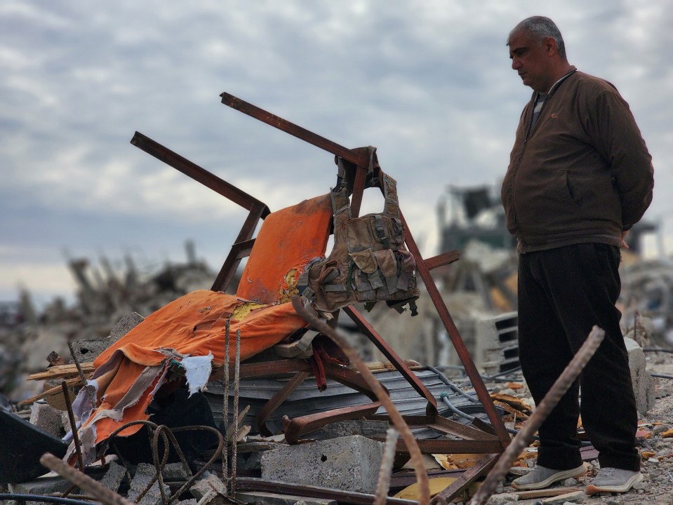 Footage of a person amidst rubble.