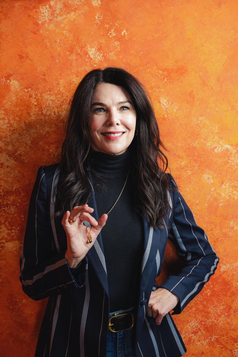 Lauren Graham of "Twinless" leans against an orange wall