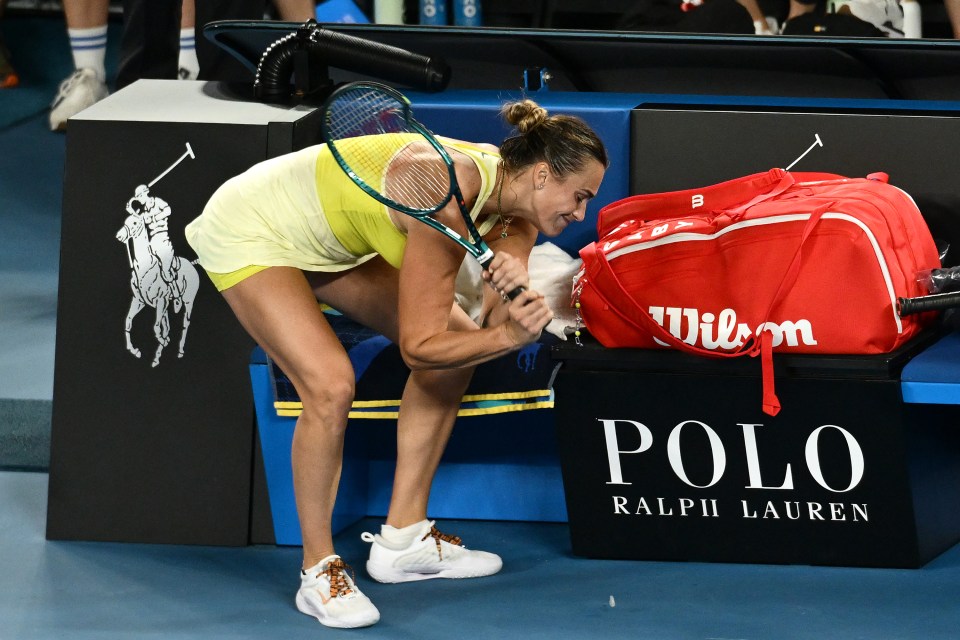 Aryna Sabalenka smashing her racket after a tennis match defeat.