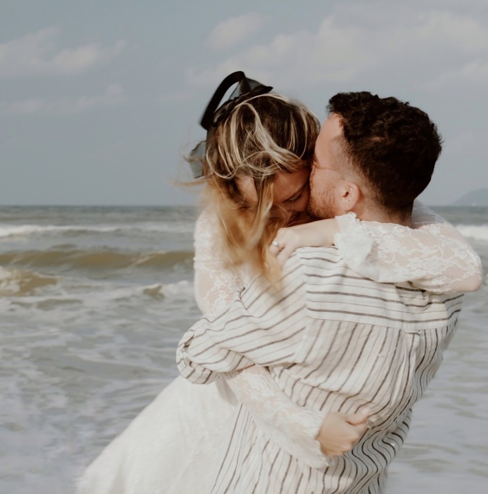 Couple embracing on a beach.