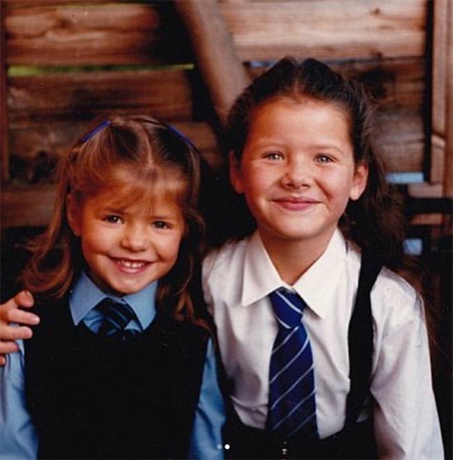 Young Holly Willoughby and her sister in school uniforms.