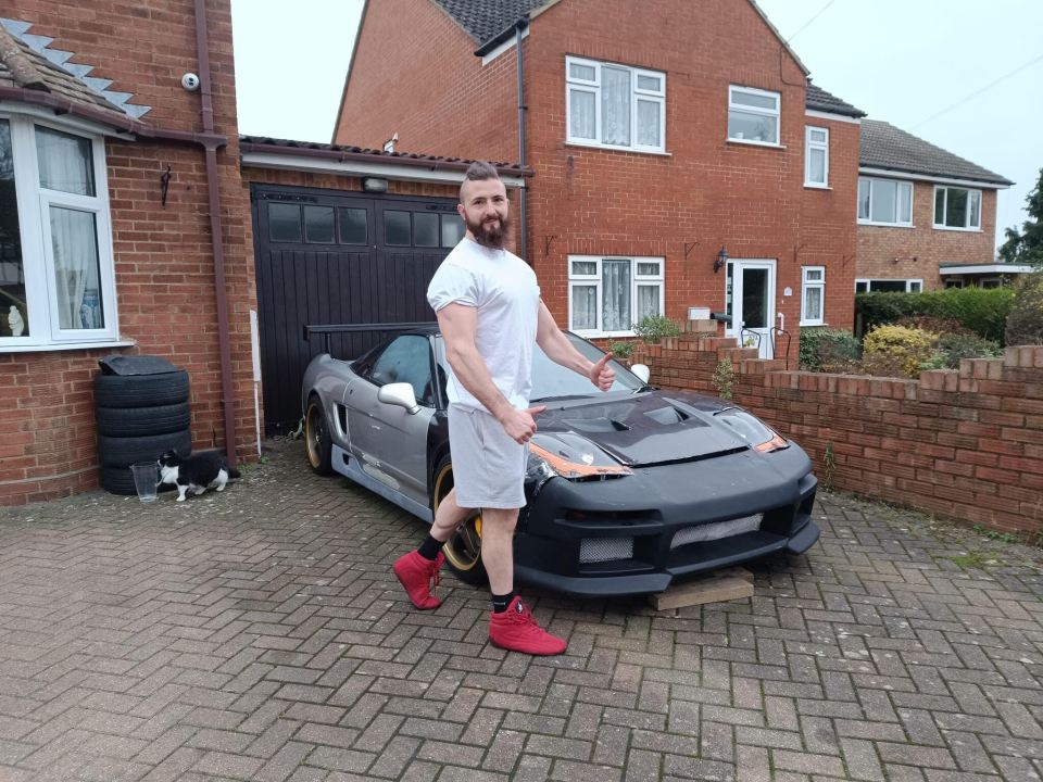 Man standing by his modified Honda NSX.