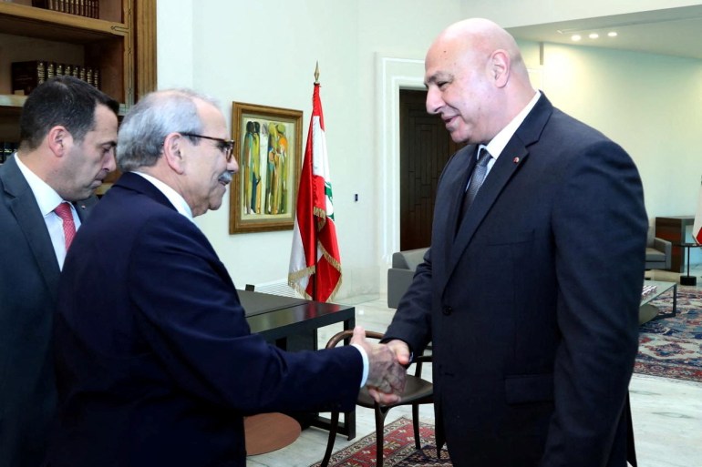 Nawaf Salam shakes hands with Joseph Aoun