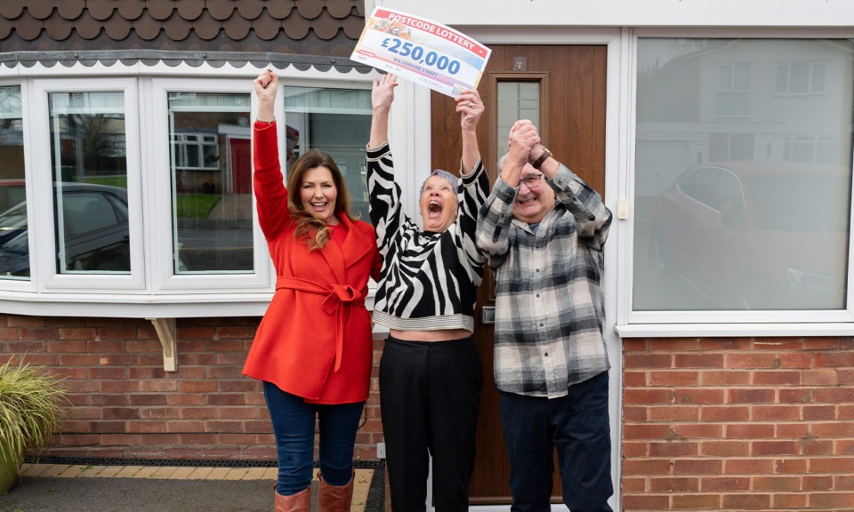 Lottery winners holding a large check for £250,000.