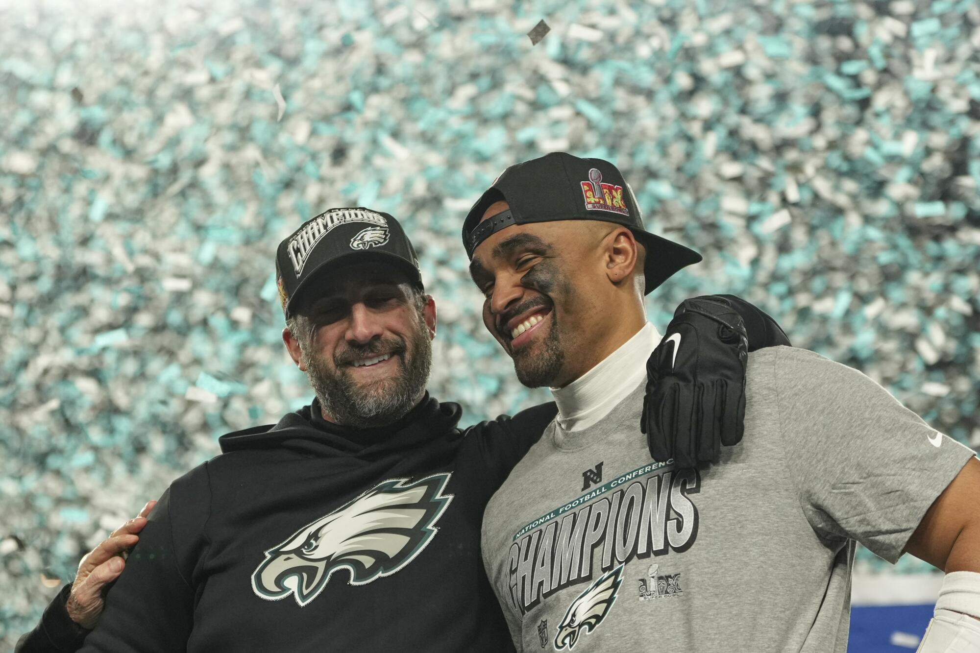 Confetti falls on coach Nick Sirianni, left, and quarterback Jalen Hurts after the Eagles won the NFC championship.