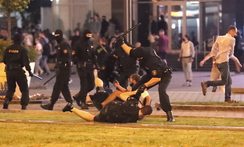 Riot police officer hitting a demonstrator during a protest in Minsk, Belarus.