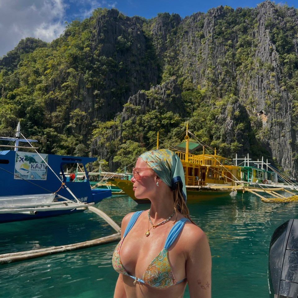 Woman in bikini on boat, tropical background.