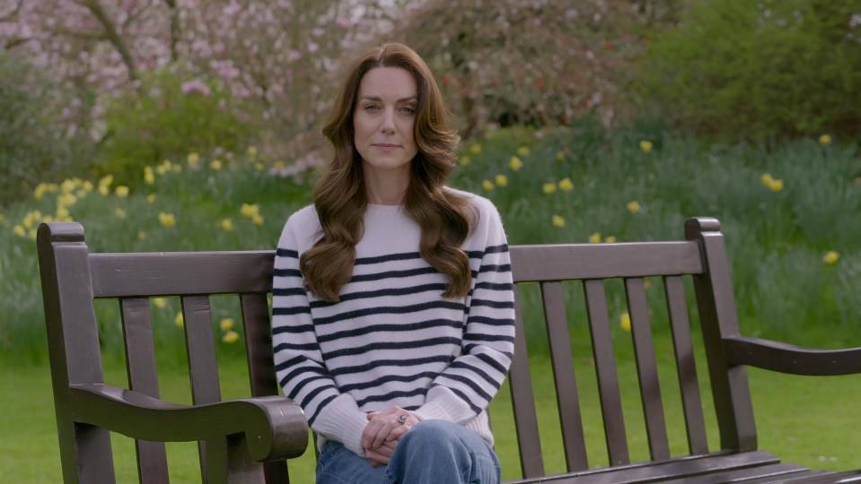 The Princess of Wales sitting on a park bench.