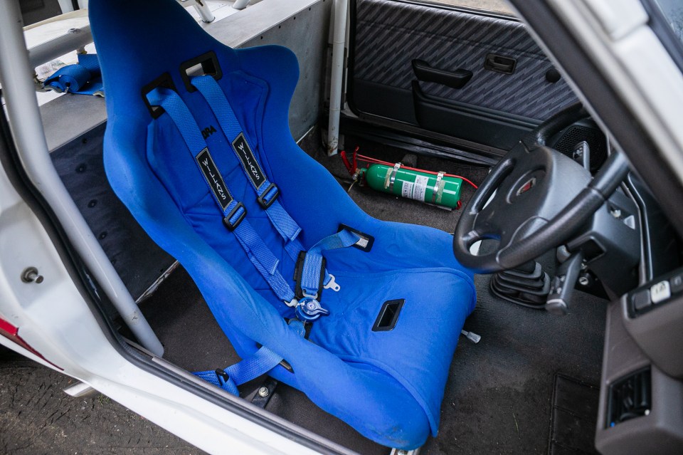 Interior of a record-breaking 1989 MG Metro GTI, showing a blue racing seat and safety equipment.