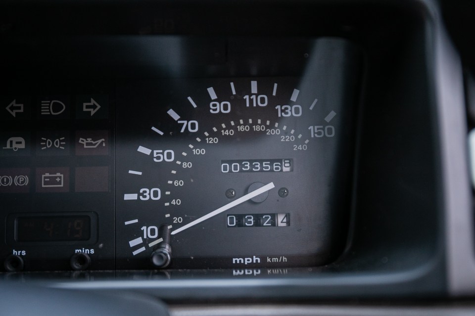 Close-up of a car's odometer showing 3356 miles.