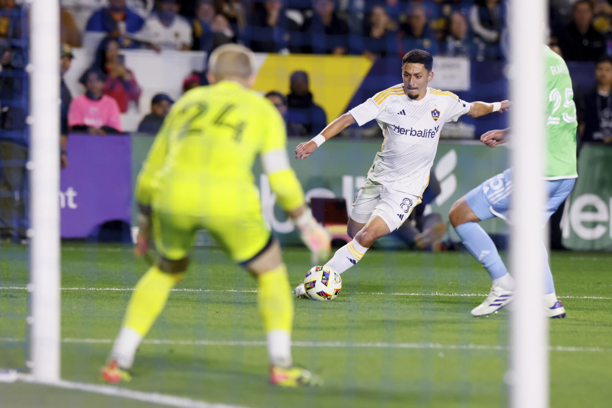 Galaxy midfielder Mark Delgado tries to shoot past a Seattle Sounders defender during a playoff game in November.