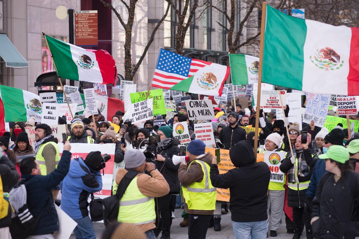 Protesters in Chicago wave U.S. and Mexican flags. 