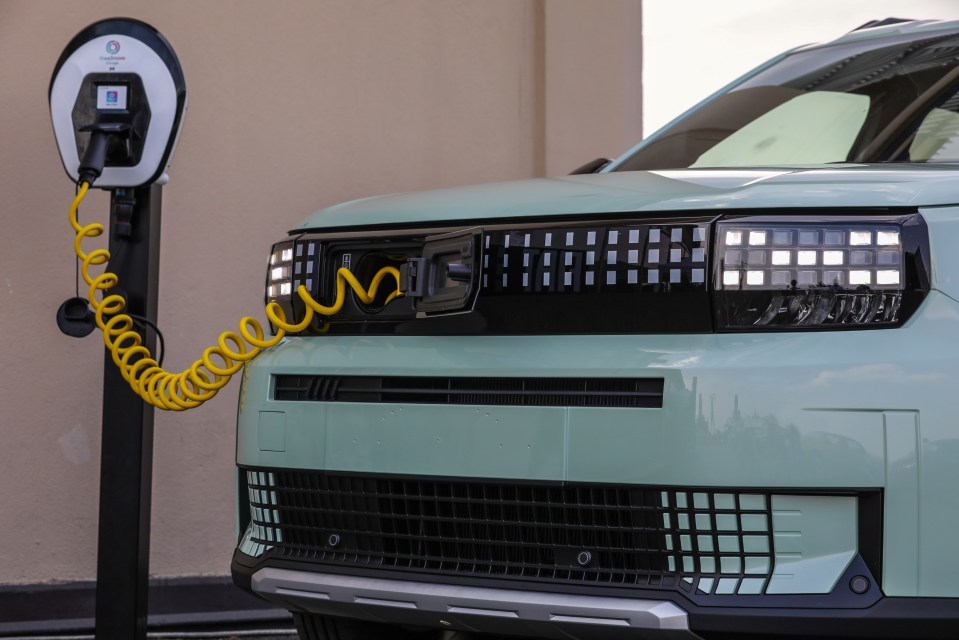 Light green electric car charging at a charging station.