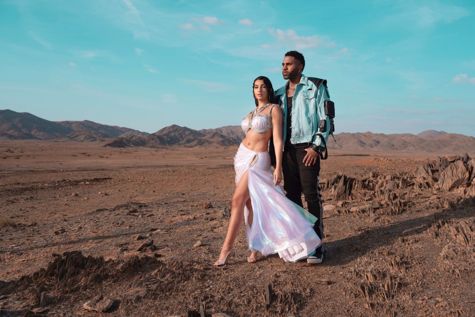 Jason Derulo and Nora Fatehi in a desert landscape.