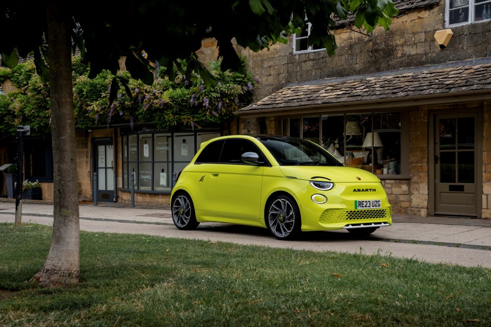 Bright yellow Fiat 600e parked on a street.