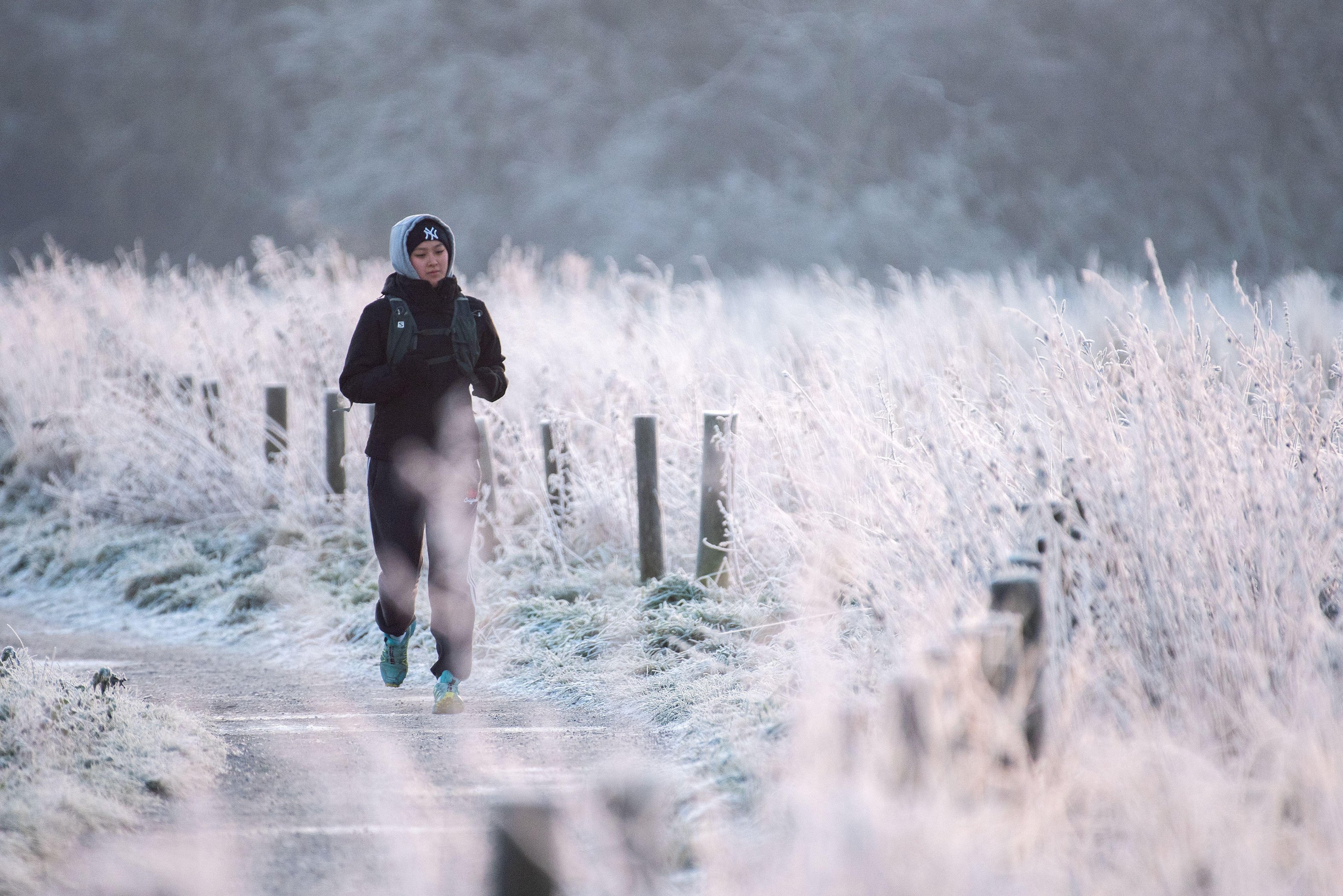 Jogger running on a frosty path.