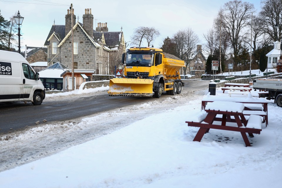 Snow plow clearing a snow-covered road.