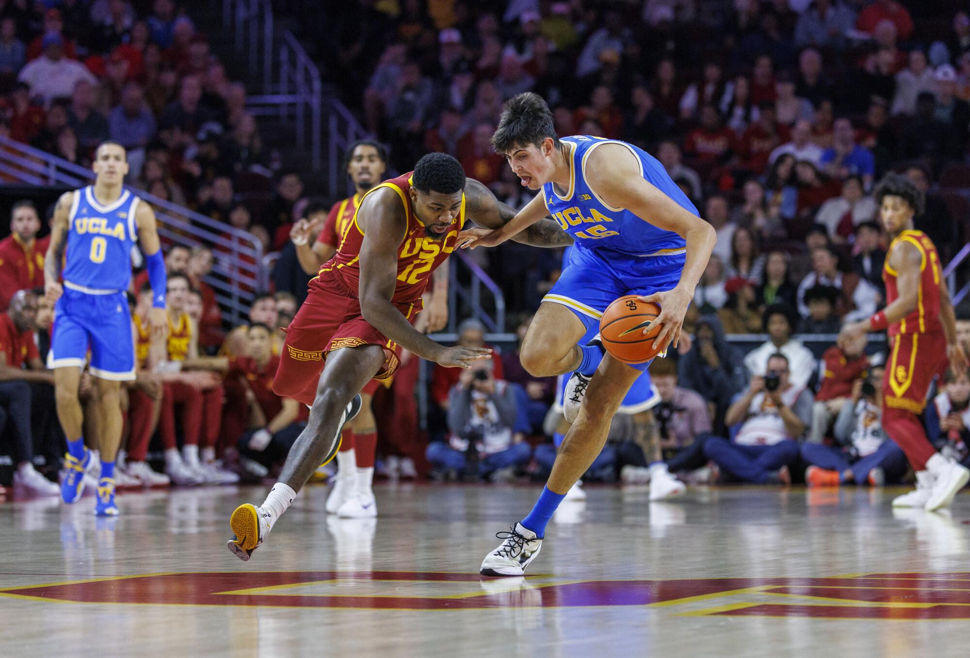 UCLA center Aday Mara regains possession of the ball after an attempted steal by USC forward Rashaun Agee at Galen Center.