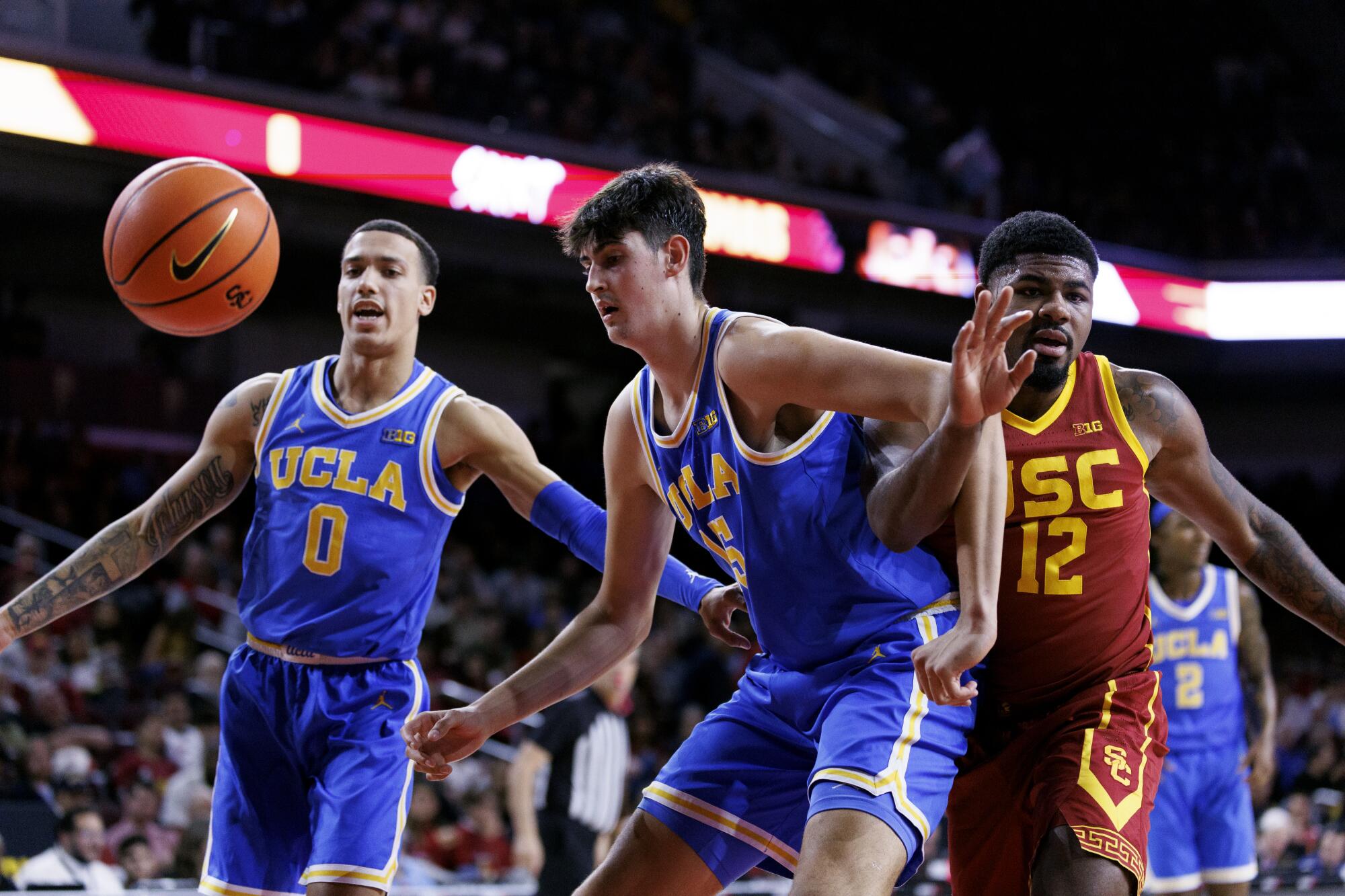 UCLA center Aday Mara and guard Kobe Johnson box out USC forward Rashaun Agee 