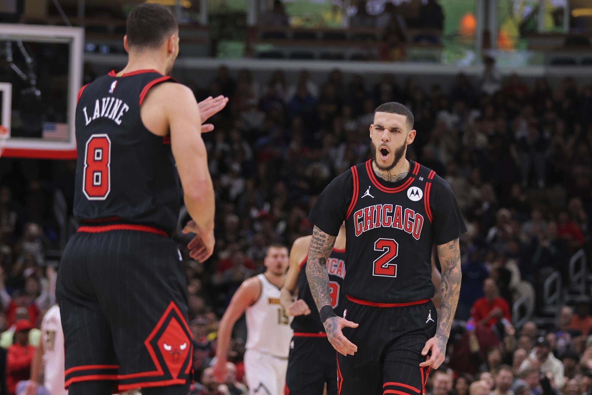 Chicago Bulls guard Lonzo Ball, right, celebrates after guard Zach LaVine, left, hit a three-pointer on Monday.