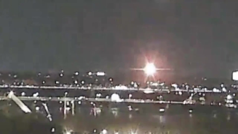 Screengrab of a plane and helicopter colliding mid-air and crashing into the Potomac River.