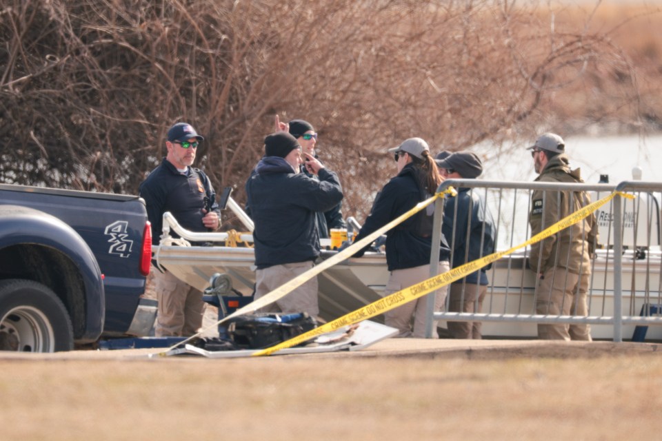 Law enforcement officers investigating a plane crash.