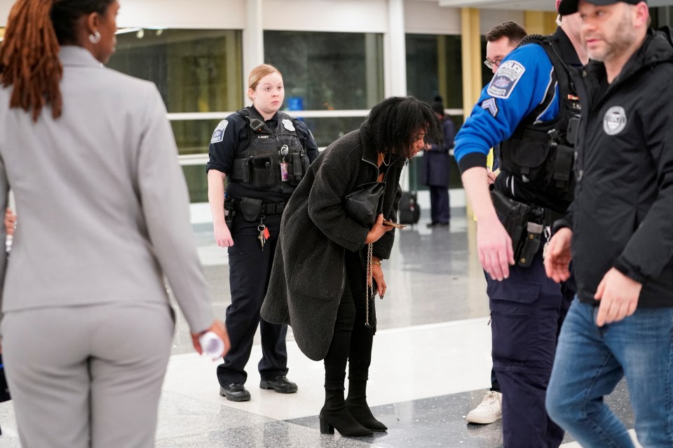 A person reacts at an airport after a plane crash.