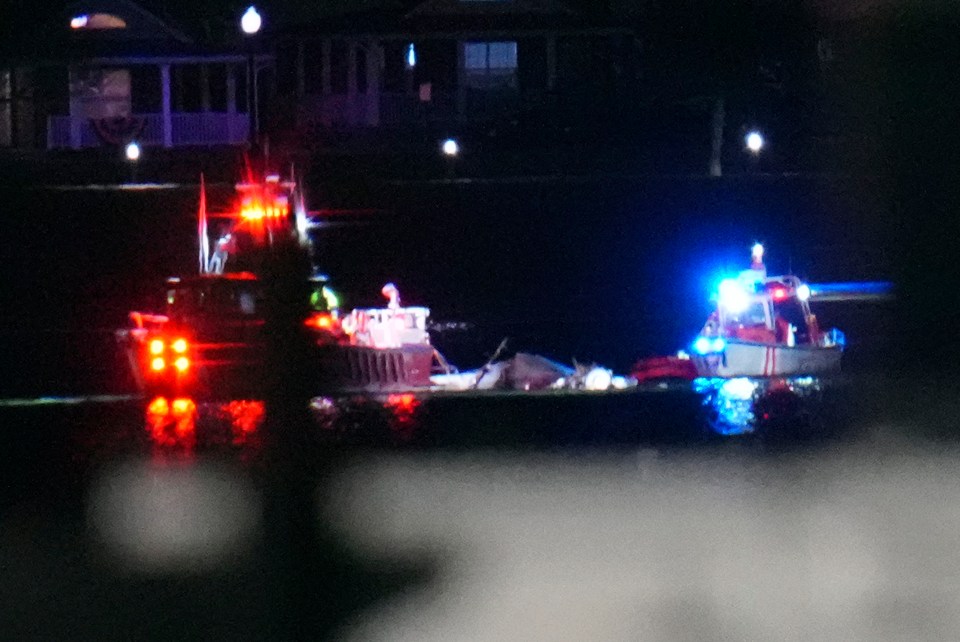 Emergency boats at night responding to an incident on the water.