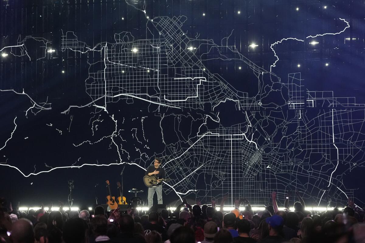 John Mayer onstage at the Forum for FireAid.