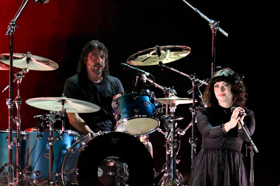 Violet Grohl performing onstage with Dave Grohl.