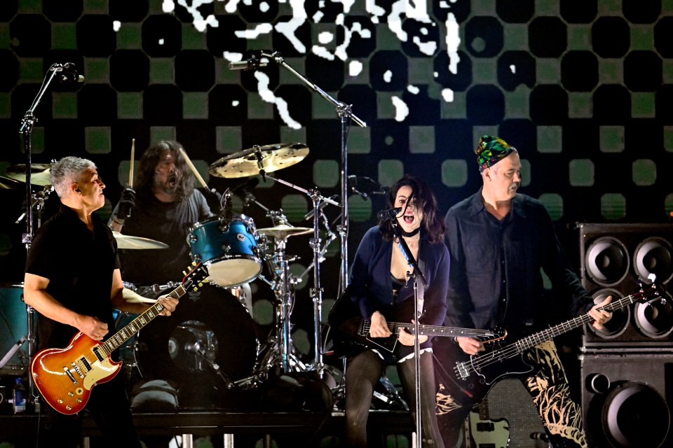 St. Vincent performing onstage with Pat Smear, Dave Grohl, and Krist Novoselic.