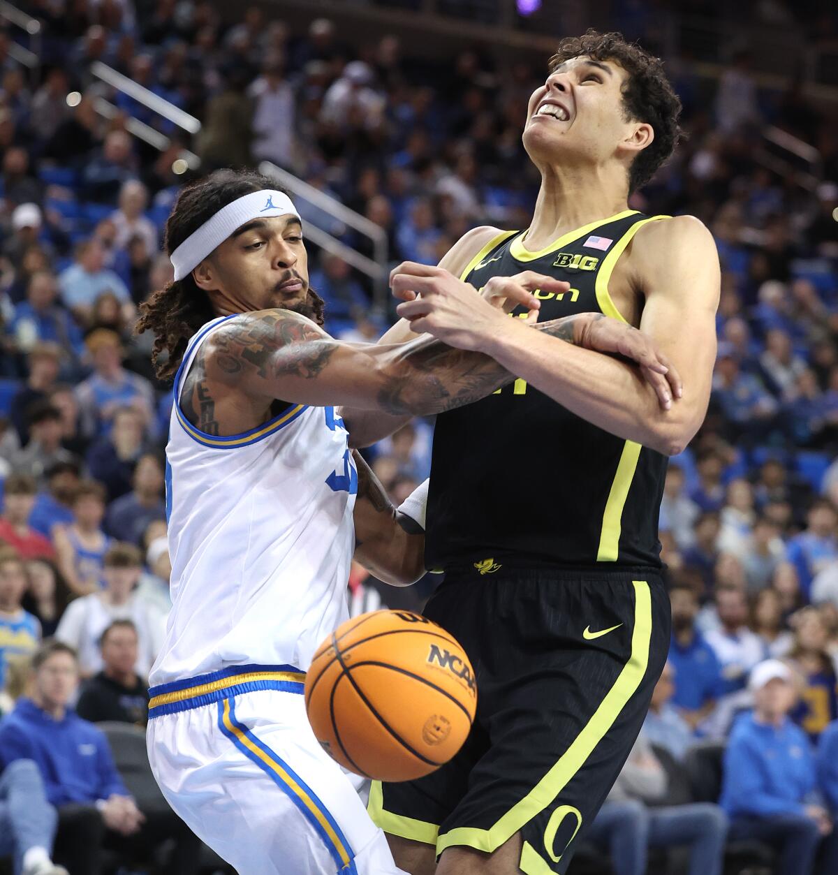 UCLA's Skyy Clark knocks the ball out of the hands of Oregon's Brandon Angel in the first half Thursday.