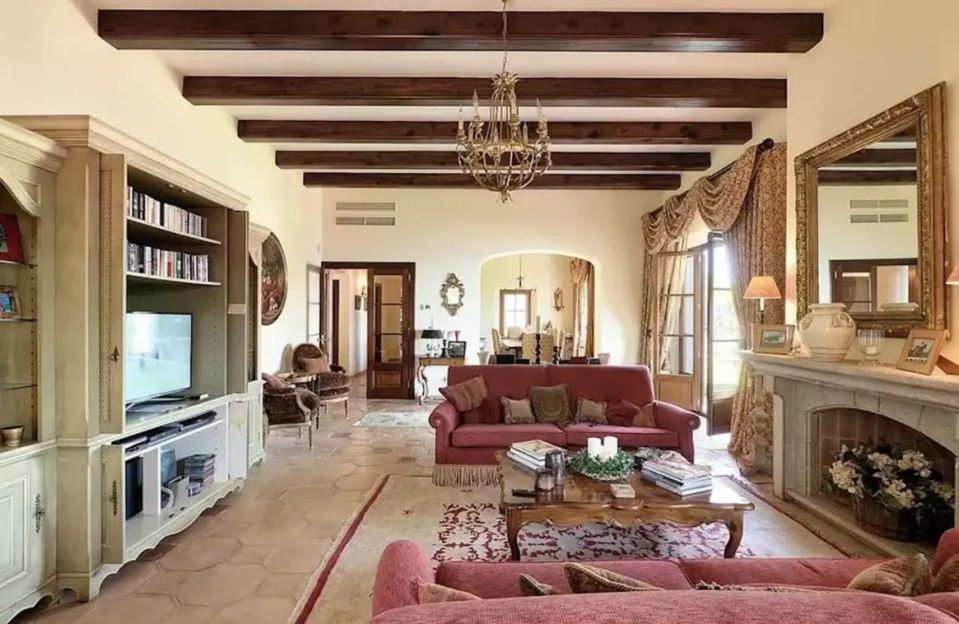 Living room with fireplace and large sofa.