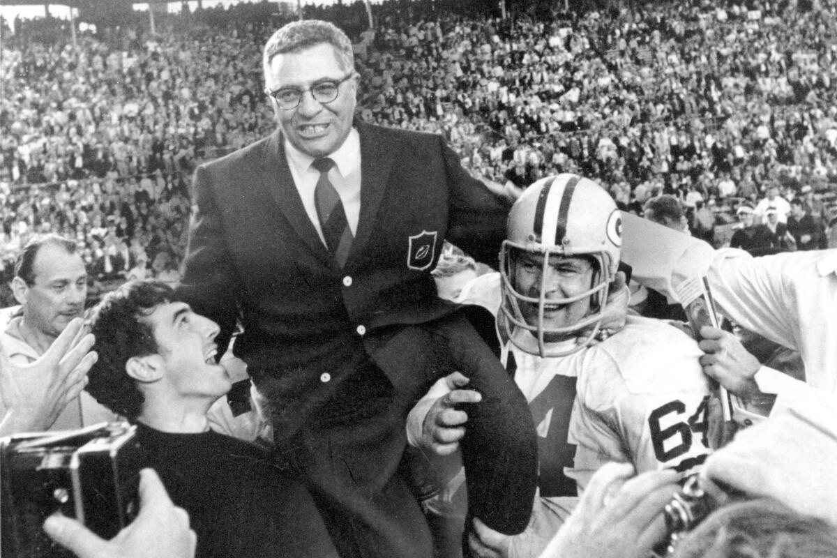 Coach Vince Lombardi is carried off the field after the Packers defeated the  Raiders 33-14 in Super Bowl II. 