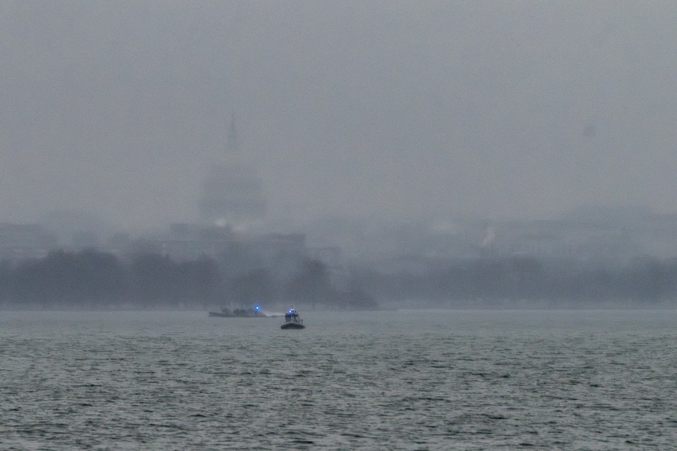 Rescue boats at a foggy crash site.