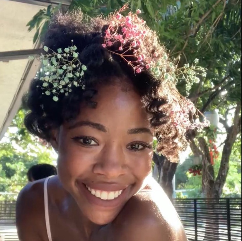 Portrait of Kiah Duggins with flowers in her hair.