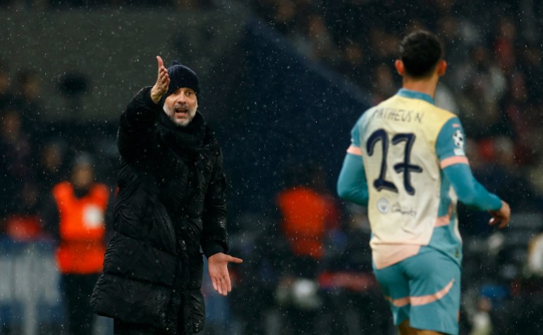 Soccer Football - Champions League - Paris St Germain v Manchester City - Parc des Princes, Paris, France - January 22, 2025 Manchester City manager Pep Guardiola gives instructions to Matheus Nunes REUTERS/Gonzalo Fuentes