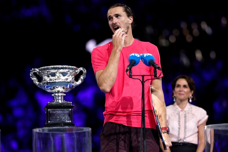 Germany's Alexander Zverev speaks after receiving runners up trophy during a ceremony after his men's singles final match against Italy's Jannik Sinner on day fifteen of the Australian Open tennis tournament in Melbourne on January 26, 2025. (Photo by Martin KEEP / AFP) / -- IMAGE RESTRICTED TO EDITORIAL USE - STRICTLY NO COMMERCIAL USE --