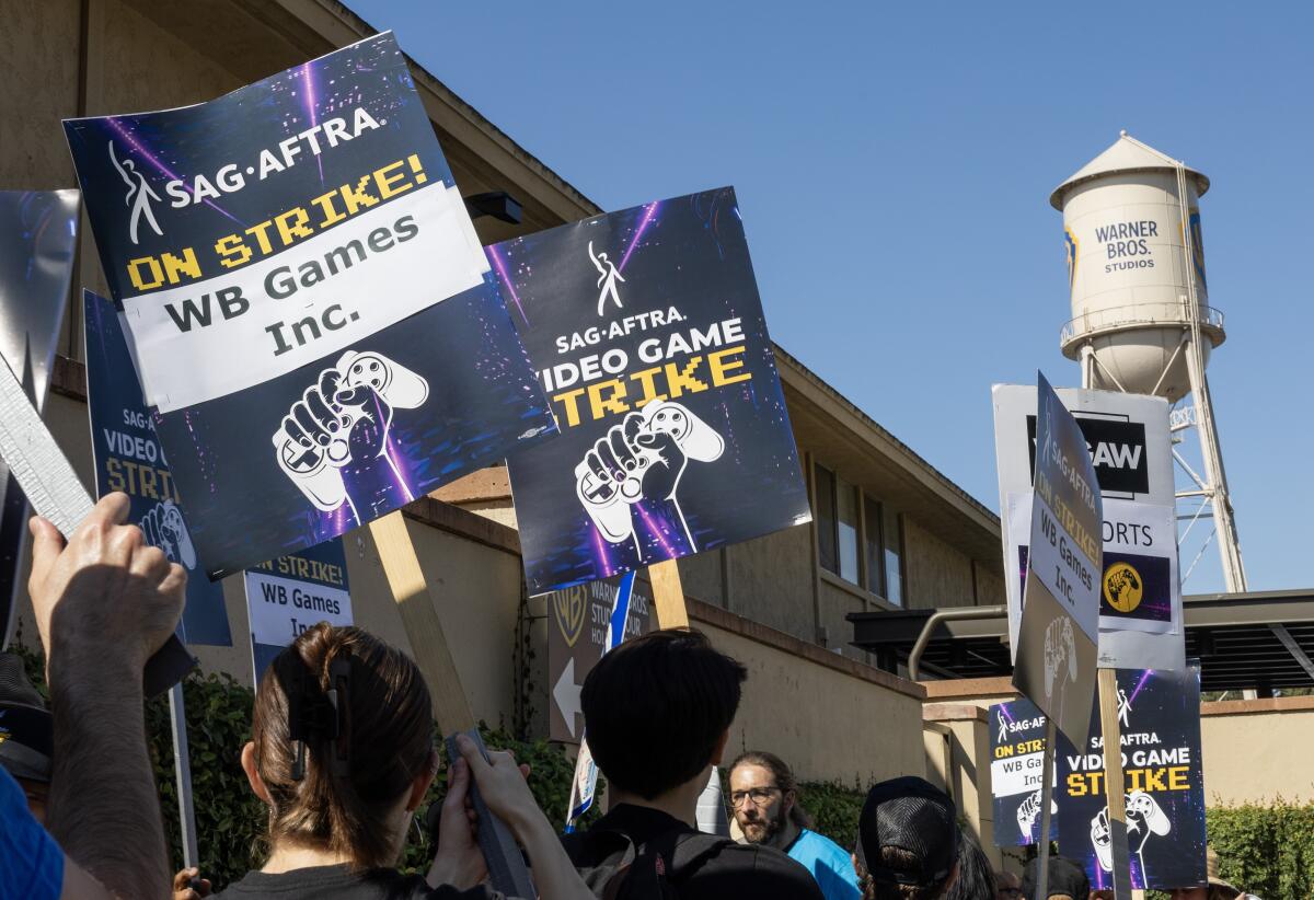 Striking video game actors picketing outside Warner Bros. Studio in Burbank