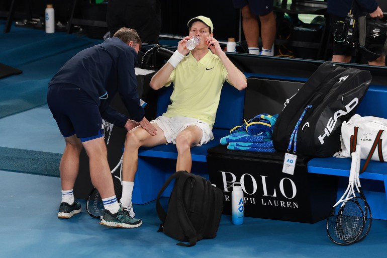 MELBOURNE, AUSTRALIA - JANUARY 24: Jannik Sinner of Italy receives the medical treatment in the Men's Singles Semifinal against Ben Shelton of the United States during day 13 of the 2025 Australian Open at Melbourne Park on January 24, 2025 in Melbourne, Australia. (Photo by Darrian Traynor/Getty Images)