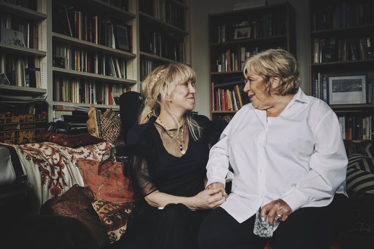 Courtney Love sits next to Marianne Faithfull on a sofa