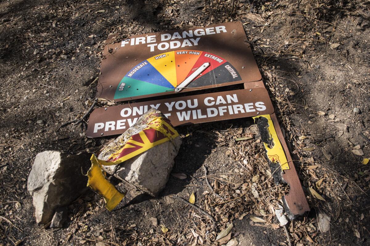 A fire danger sign damaged by the Bobcat fire at Chantry Flat in the Angeles National Forest on Saturday, Nov. 21, 2020.